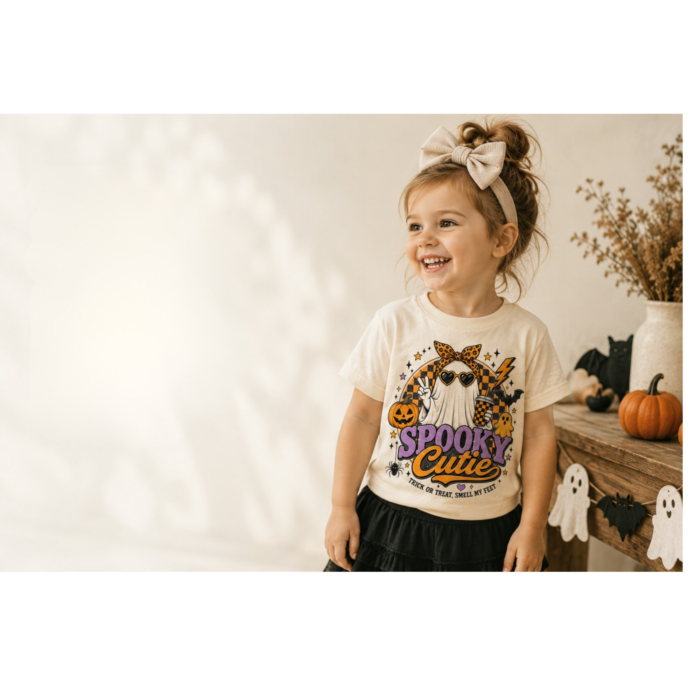 Child wearing a little tee in a soft nursery