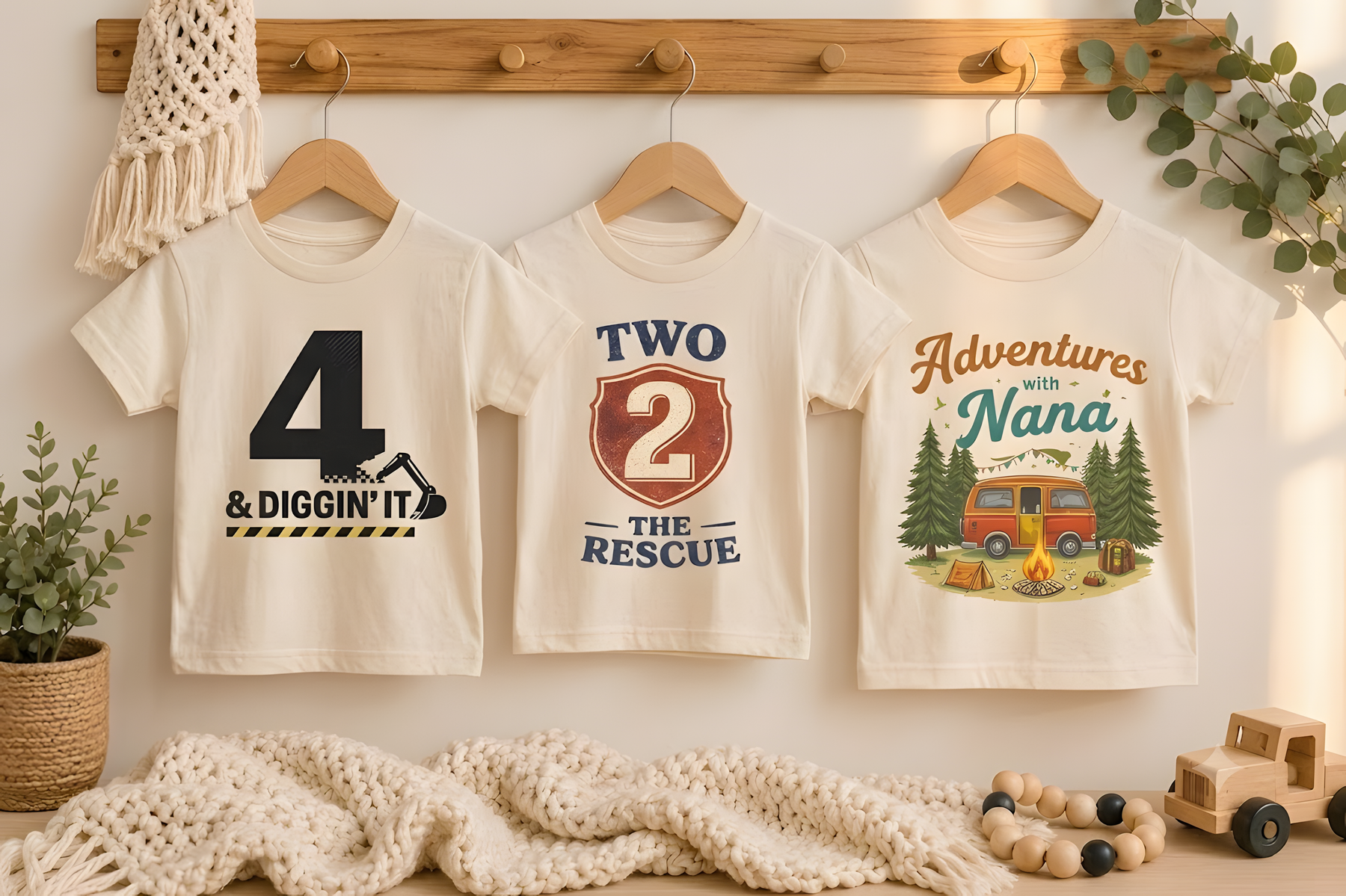 Three boutique tees hanging in a warm nursery setting