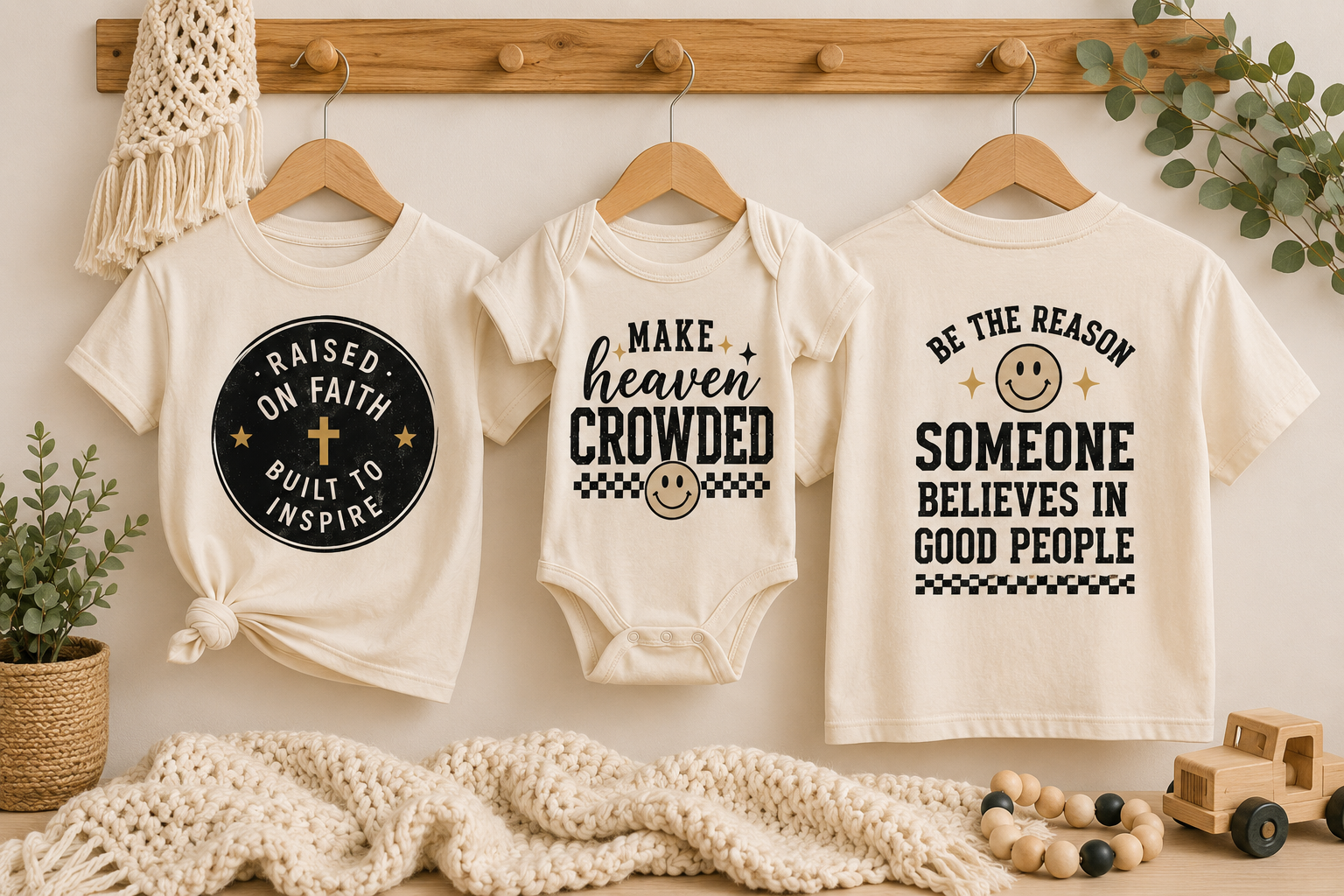 Three boutique tees hanging in a warm nursery setting